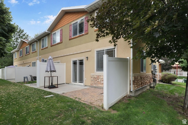 3901 W Pine Landing Way S, West Jordan, UT 84084 - rear view of house with stone siding, a patio area, and stucco siding