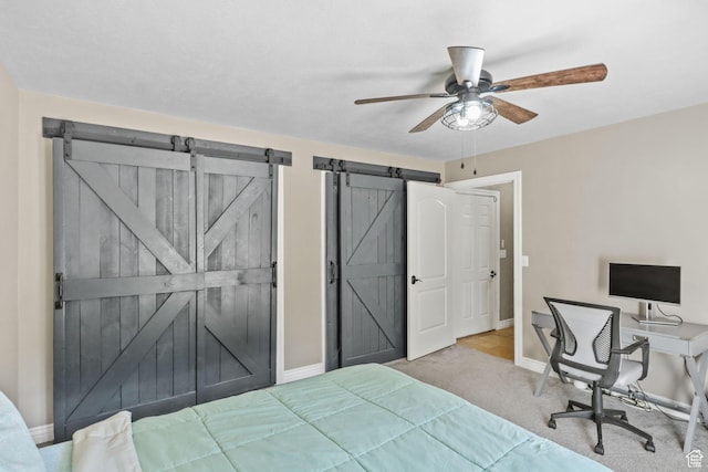9618 S Ruskin Cir E, Sandy, UT 84092 - bedroom featuring a barn door, carpet flooring, and ceiling fan