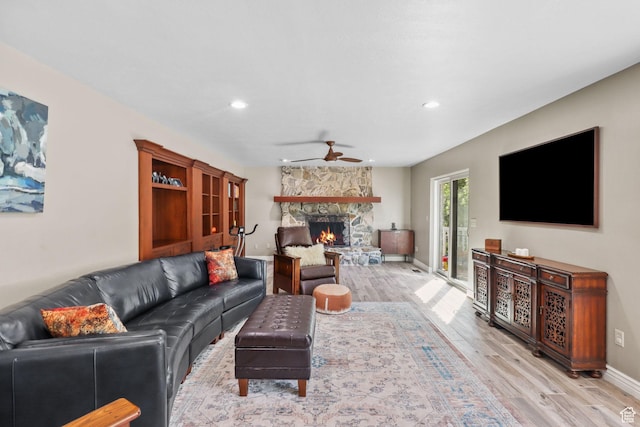 9618 S Ruskin Cir E, Sandy, UT 84092 - living room featuring light wood-type flooring, ceiling fan, a stone fireplace, and recessed lighting