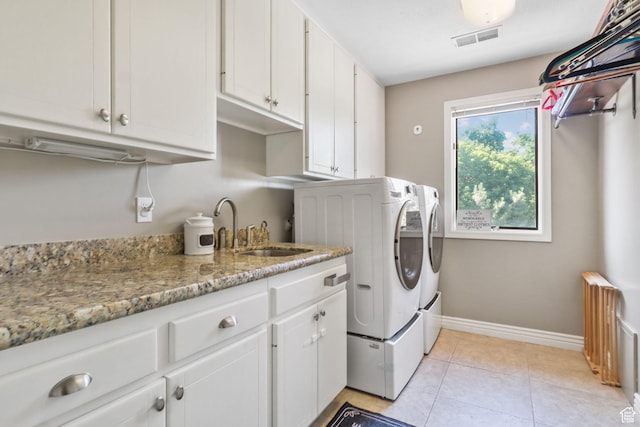 9618 S Ruskin Cir E, Sandy, UT 84092 - laundry room with washer and clothes dryer, cabinet space, and light tile patterned floors
