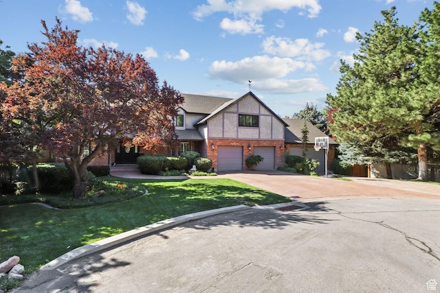 9618 S Ruskin Cir E, Sandy, UT 84092 - tudor home featuring concrete driveway, an attached garage, and brick siding