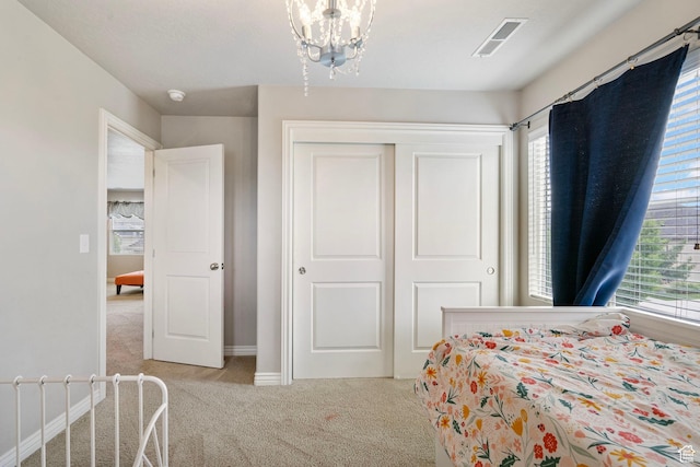 598 W Sandhill Dr, Lehi, UT 84043 - bedroom with light carpet, multiple windows, a closet, and a chandelier