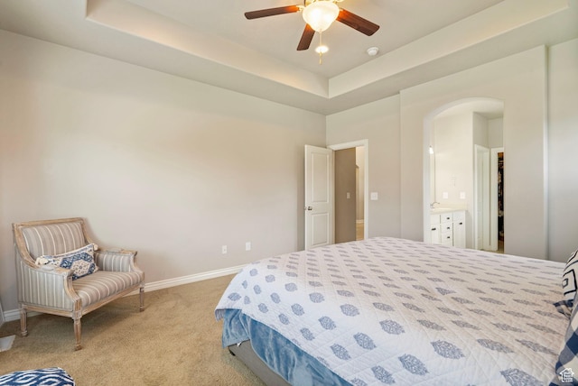 598 W Sandhill Dr, Lehi, UT 84043 - bedroom featuring arched walkways, light colored carpet, and a tray ceiling