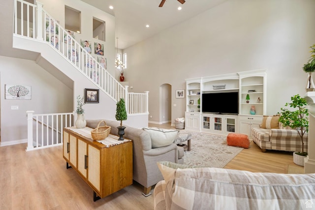 598 W Sandhill Dr, Lehi, UT 84043 - living room featuring a towering ceiling, light wood-type flooring, arched walkways, ceiling fan, and recessed lighting