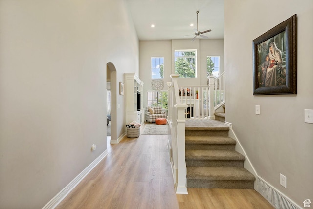 598 W Sandhill Dr, Lehi, UT 84043 - stairway with arched walkways, ceiling fan, wood finished floors, recessed lighting, and a towering ceiling