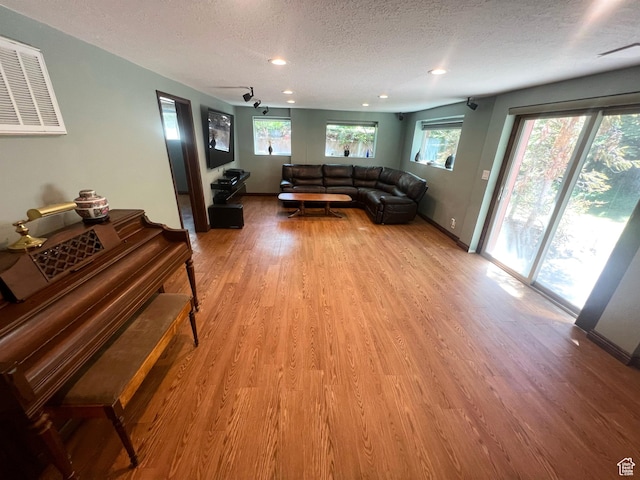 3550 E Oakview Dr, Millcreek, UT 84124 - living room with a textured ceiling, light wood-style flooring, and recessed lighting