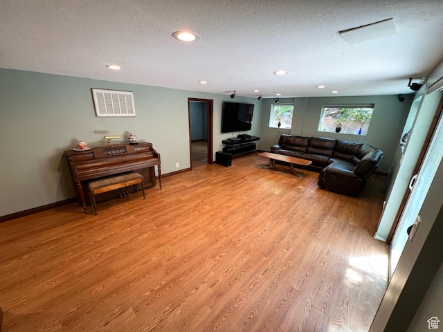 3550 E Oakview Dr, Millcreek, UT 84124 - living room with light wood-style flooring, a textured ceiling, and recessed lighting