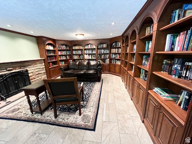 3550 E Oakview Dr, Millcreek, UT 84124 - living area featuring wall of books, a textured ceiling, built in shelves, crown molding, and recessed lighting