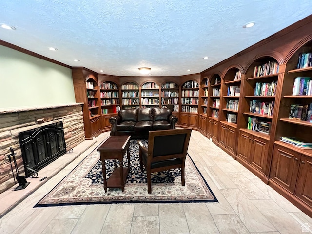 3550 E Oakview Dr, Millcreek, UT 84124 - living area with bookshelves, built in features, ornamental molding, recessed lighting, and a stone fireplace
