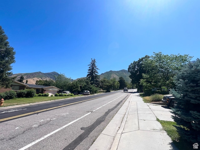3550 E Oakview Dr, Millcreek, UT 84124 - view of asphalt road featuring a mountain view, curbs, and sidewalks