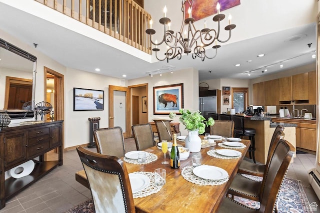 1290 Pinnacle Dr, Park City, UT 84060 - tiled dining space with track lighting, a chandelier, and baseboard heating