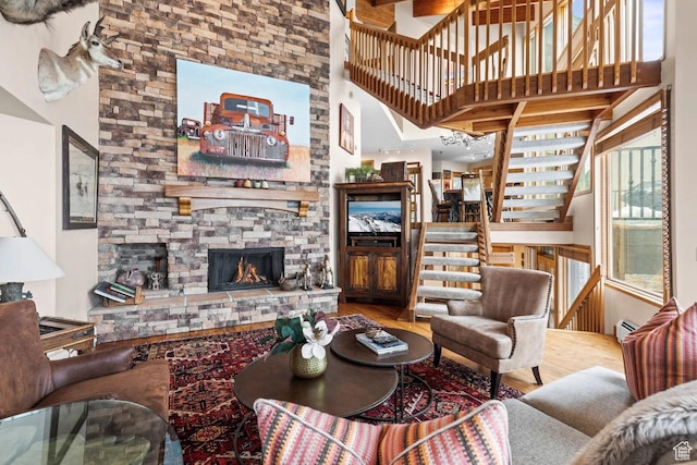 1290 Pinnacle Dr, Park City, UT 84060 - living area with wood finished floors, a towering ceiling, stairway, and a stone fireplace