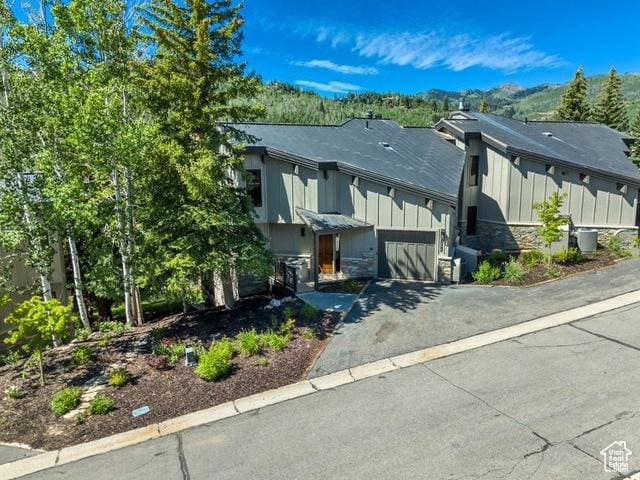 1290 Pinnacle Dr, Park City, UT 84060 - view of front of home with asphalt driveway, board and batten siding, and stone siding