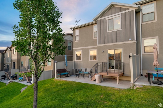 14584 S Heatherly Ln, Herriman, UT 84096 - back of house featuring a patio, board and batten siding, and stucco siding