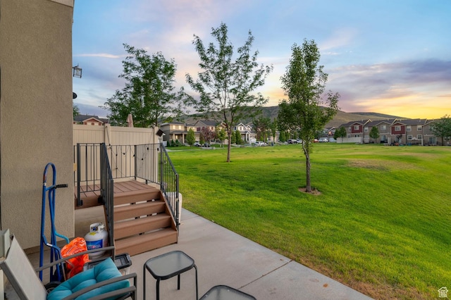 14584 S Heatherly Ln, Herriman, UT 84096 - patio terrace at dusk featuring a residential view and a yard