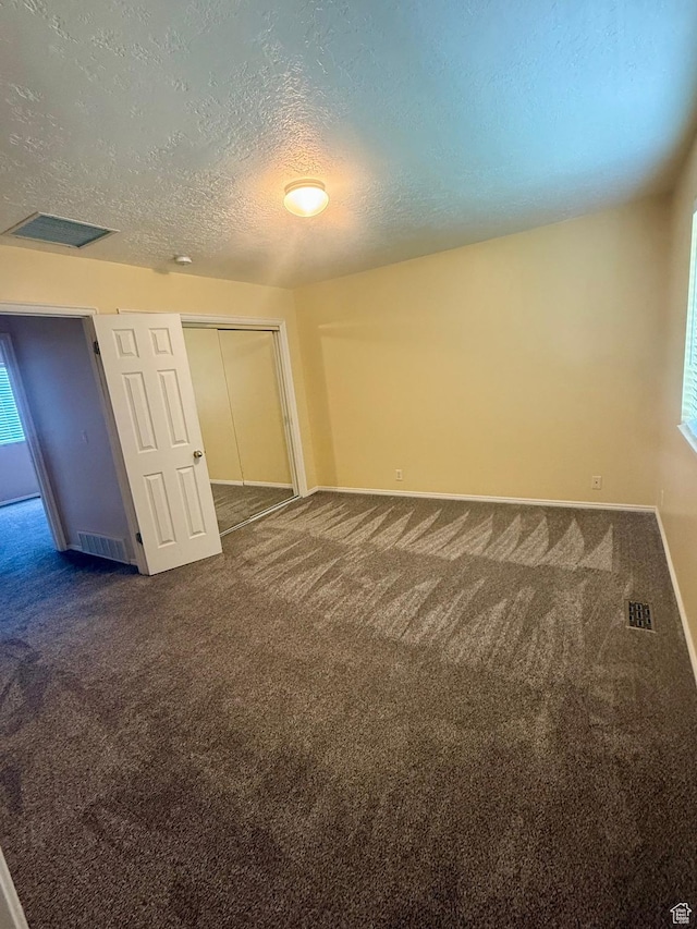 428 E 810 N, Tooele, UT 84074 - unfurnished room with dark carpet and a textured ceiling
