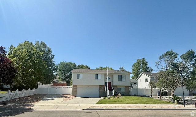 428 E 810 N, Tooele, UT 84074 - raised ranch featuring concrete driveway, an attached garage, and brick siding