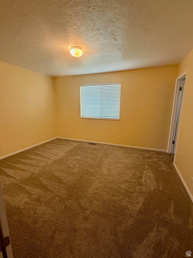 428 E 810 N, Tooele, UT 84074 - empty room with carpet flooring and a textured ceiling