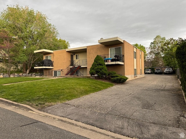 266 E Center St, Centerville, UT 84014 - view of front of house featuring brick siding, a front yard, and stairway