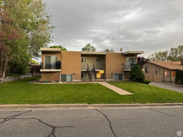 266 E Center St, Centerville, UT 84014 - back of property featuring a yard, brick siding, and stairs
