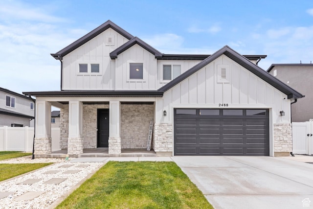 2488 W 2940 S, Syracuse, UT 84075 - modern farmhouse style home featuring covered porch, stone siding, an attached garage, and board and batten siding