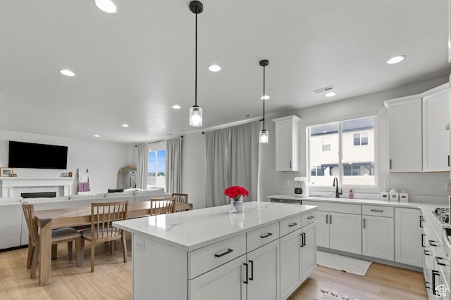 2488 W 2940 S, Syracuse, UT 84075 - kitchen featuring recessed lighting, open floor plan, a center island, white cabinetry, and light stone counters