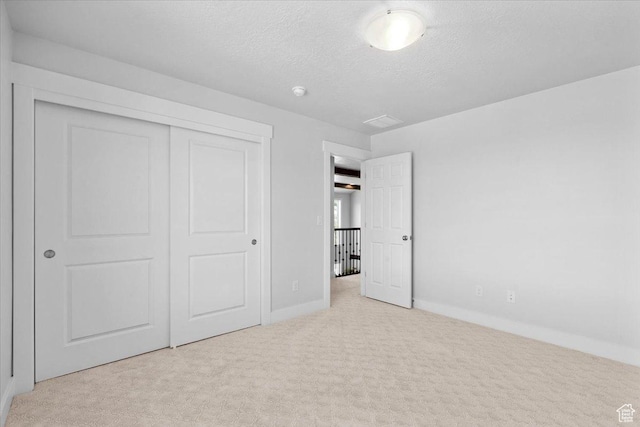 10865 S Hiddenwood Dr, Sandy, UT 84092 - unfurnished bedroom with carpet floors, a textured ceiling, and a closet