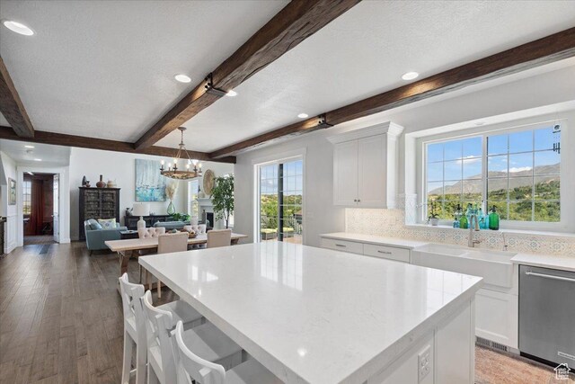 10865 S Hiddenwood Dr, Sandy, UT 84092 - kitchen featuring dishwasher, beamed ceiling, a chandelier, white cabinetry, and light wood-style flooring