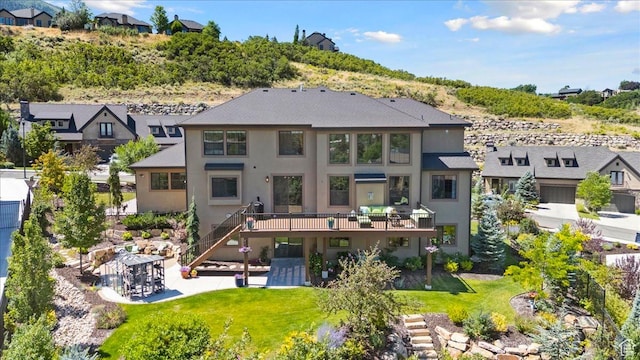 10865 S Hiddenwood Dr, Sandy, UT 84092 - rear view of house featuring stucco siding, a deck, a residential view, and a yard