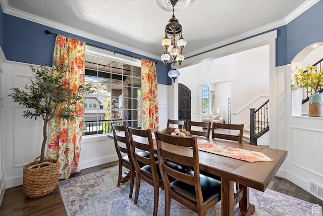 10865 S Hiddenwood Dr, Sandy, UT 84092 - dining area with ornamental molding, wood finished floors, a textured ceiling, and stairway