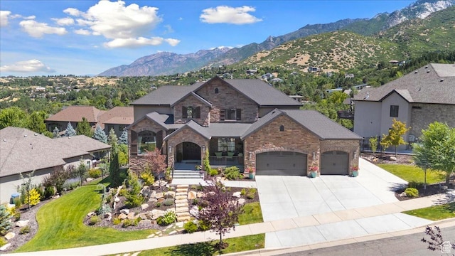 10865 S Hiddenwood Dr, Sandy, UT 84092 - view of front of home featuring driveway, a mountain view, a garage, stone siding, and a porch