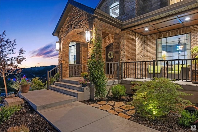 10865 S Hiddenwood Dr, Sandy, UT 84092 - view of exterior entry with a porch, brick siding, and stone siding