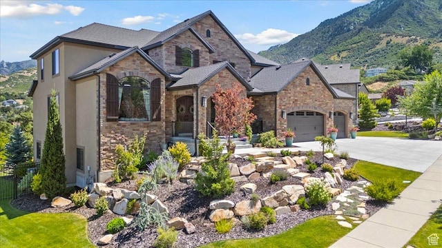 10865 S Hiddenwood Dr, Sandy, UT 84092 - french country home with concrete driveway, stone siding, a mountain view, and stucco siding