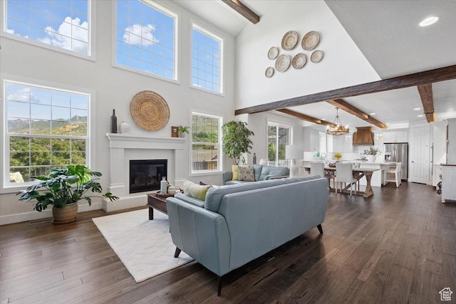 10865 S Hiddenwood Dr, Sandy, UT 84092 - living area featuring beam ceiling, dark wood-style flooring, a glass covered fireplace, plenty of natural light, and recessed lighting