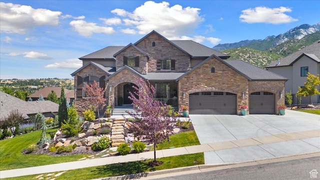 10865 S Hiddenwood Dr, Sandy, UT 84092 - view of front of property with driveway, a garage, a mountain view, and stone siding