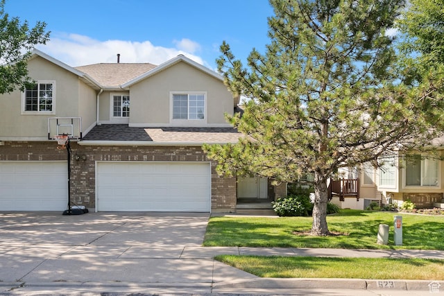 623 W 550 S, Centerville, UT 84014 - townhome / multi-family property with an attached garage, driveway, a front lawn, brick siding, and stucco siding