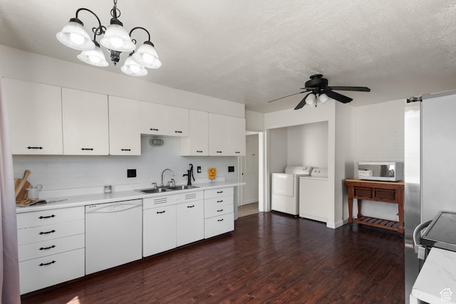 2536 S 1000 W, Syracuse, UT 84075 - kitchen featuring white appliances, separate washer and dryer, light countertops, tasteful backsplash, and dark wood-type flooring