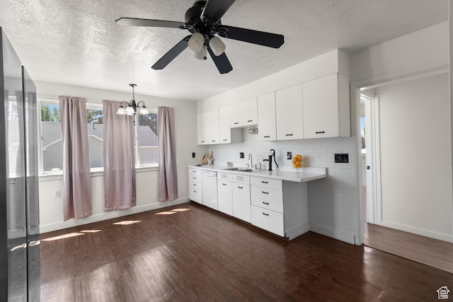 2536 S 1000 W, Syracuse, UT 84075 - kitchen with light countertops, dark wood-type flooring, a ceiling fan, a textured ceiling, and white cabinets