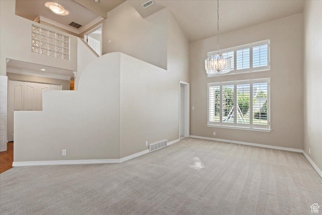 1116 W Wasatch Downs Dr, South Jordan, UT 84095 - unfurnished living room featuring a high ceiling, a chandelier, carpet flooring, and healthy amount of natural light