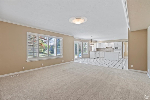 1116 W Wasatch Downs Dr, South Jordan, UT 84095 - unfurnished living room featuring ornamental molding and light carpet