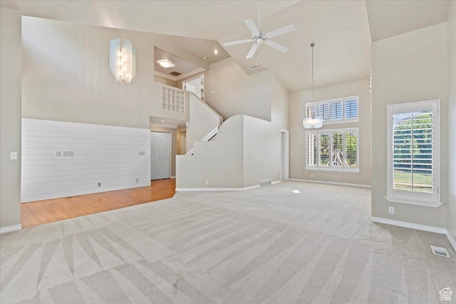 1116 W Wasatch Downs Dr, South Jordan, UT 84095 - unfurnished living room with high vaulted ceiling, carpet flooring, a chandelier, and a ceiling fan