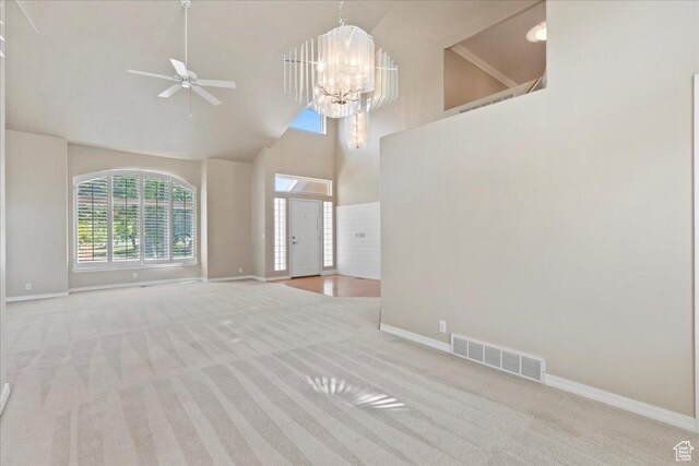 1116 W Wasatch Downs Dr, South Jordan, UT 84095 - unfurnished living room with carpet flooring, plenty of natural light, high vaulted ceiling, ceiling fan, and a chandelier