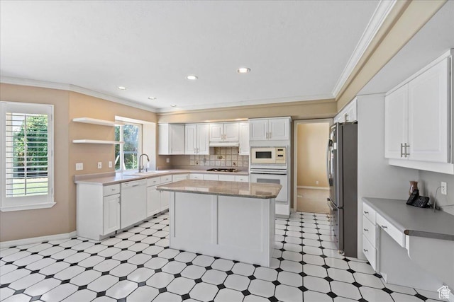 1116 W Wasatch Downs Dr, South Jordan, UT 84095 - kitchen featuring white appliances, light floors, a kitchen island, white cabinets, and ornamental molding