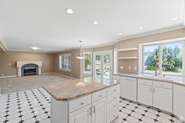 1116 W Wasatch Downs Dr, South Jordan, UT 84095 - kitchen featuring white dishwasher, light floors, a glass covered fireplace, a center island, and white cabinetry