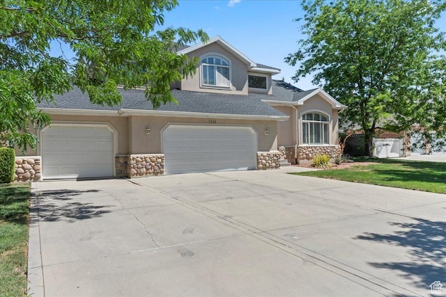 1116 W Wasatch Downs Dr, South Jordan, UT 84095 - traditional-style house featuring stone siding, stucco siding, driveway, and an attached garage