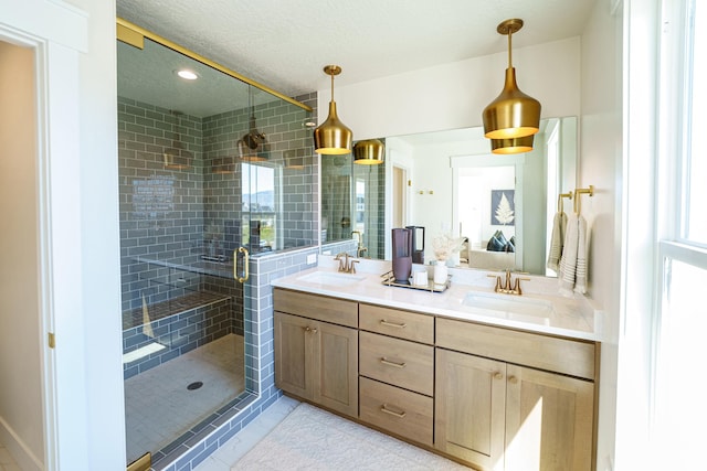 11448 S Watercourse Rd, South Jordan, UT 84009 - full bath featuring double vanity, a stall shower, a textured ceiling, plenty of natural light, and recessed lighting