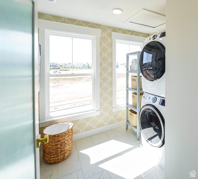 11448 S Watercourse Rd, South Jordan, UT 84009 - laundry area with stacked washer / drying machine, wallpapered walls, light marble finish floors, and attic access