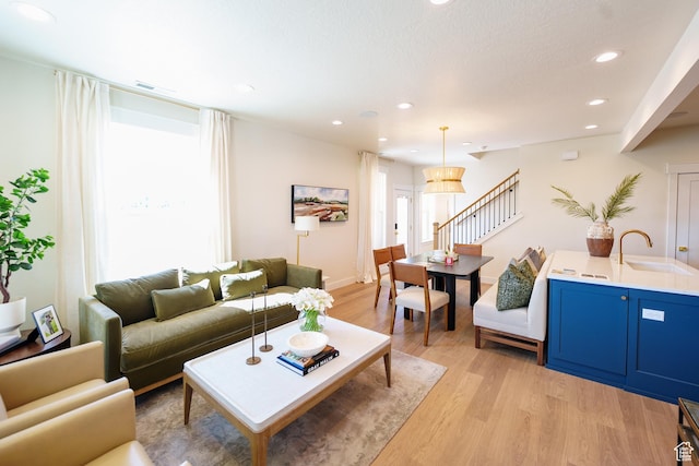 11448 S Watercourse Rd, South Jordan, UT 84009 - living room with light wood-type flooring, stairway, and recessed lighting