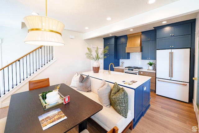 11448 S Watercourse Rd, South Jordan, UT 84009 - kitchen featuring premium appliances, custom range hood, blue cabinetry, light countertops, and recessed lighting