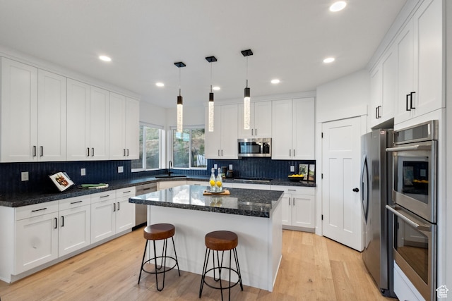 3973 N 900 W, Lehi, UT 84043 - kitchen featuring appliances with stainless steel finishes, white cabinetry, light wood-style flooring, and recessed lighting